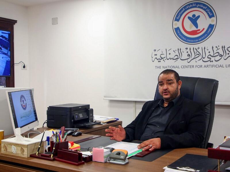 Director of the National Center for Artificial Limbs Al-Sadeq Al-Haddad, speaks during an interview at his office in Libya's port city of Misrata, on December 17, 2020. MAHMUD TURKIA / AFP