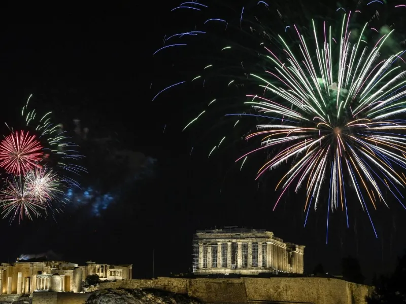 Fireworks explode over the ancient Acropolis in Athens during the new year's celebrations on December 31, 2020. LOUISA GOULIAMAKI / AFP
