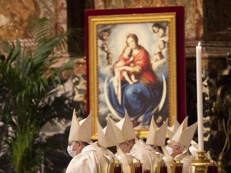Clergy, celebrates a new year Mass in St. Peter's Basilica at the Vatican on January 1, 2021. Alessandra Tarantino / POOL / AFP