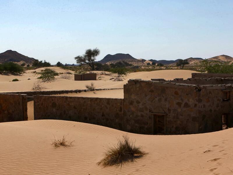 This picture taken on December 31, 2020, shows the walls of an abandoned house in the Omani village of Wadi al-Murr, about 400 kms (250 miles) southwest of the capital Muscat. Encroaching desert sands have left little evidence that Wadi al-Murr ever existed, but former inhabitants, while resigned to its destruction, are trying to preserve its memory. MOHAMMED MAHJOUB / AFP