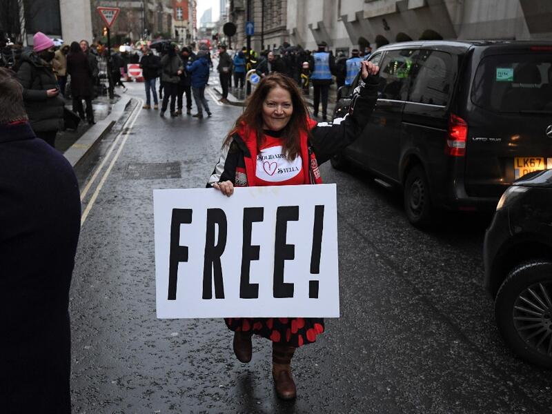 Supporters of Wikileaks founder Julian Assange celebrate outside the Old Bailey court in central London after a judge ruled that Assange should not be extradited to the United States to face espionage charges for publishing secret documents online on January 4, 2021. DANIEL LEAL-OLIVAS / AFP