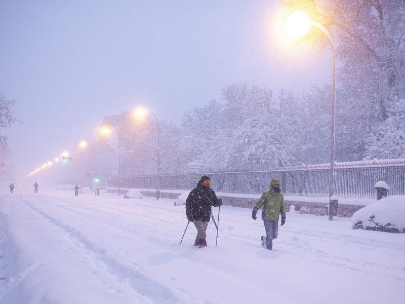People walk amid a heavy snowfall in Madrid on January 9, 2021. Heavy snow fell across much of Spain, leaving huge areas blanketed in white as Storm Filomena brought wintry weather not seen in decades to the Iberian peninsula. Benjamin Cremel / AFP
