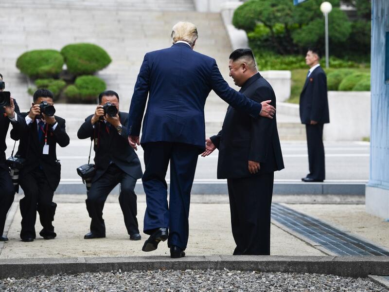 AFP presents a retrospective photo package of 60 pictures marking the 4-year presidency of President Trump. US President Donald Trump steps into the northern side of the Military Demarcation Line that divides North and South Korea, as North Korea's leader Kim Jong Un looks on, in the Joint Security Area (JSA) of Panmunjom in the Demilitarized zone (DMZ) on June 30, 2019. Brendan Smialowski / AFP