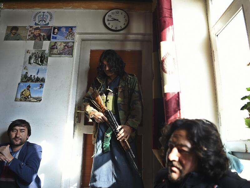 In this photo taken on January 9, 2021, Hazara armed militia for the Resistance for Justice Movement, stand inside their base ahead of a patrol against Taliban insurgents at Hisa-e-Awali Behsud district of Maidan Wardak Province. Comprising roughly 10 to 20 percent of Afghanistan's 38-million population, Hazaras have long been persecuted for their largely Shiite faith by Sunni hardliners in a country wracked by deep ethnic divisions. WAKIL KOHSAR / AFP