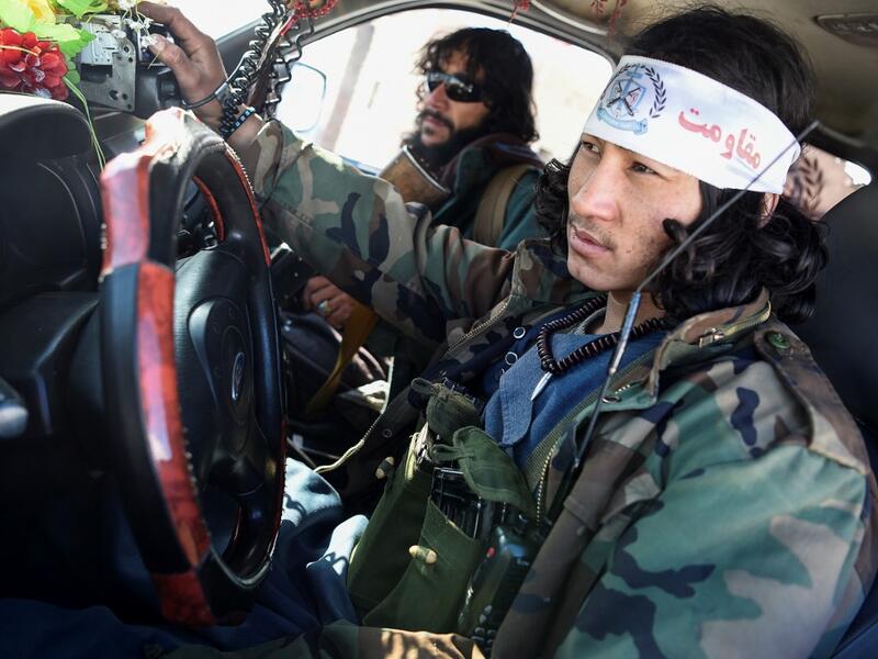 In this photo taken on January 9, 2021, Hazara armed militia for the Resistance for Justice Movement, sit in a car in front of their base during a patrol against Taliban insurgents at Hisa-e-Awali Behsud district of Maidan Wardak Province. Comprising roughly 10 to 20 percent of Afghanistan's 38-million population, Hazaras have long been persecuted for their largely Shiite faith by Sunni hardliners in a country wracked by deep ethnic divisions. WAKIL KOHSAR / AFP