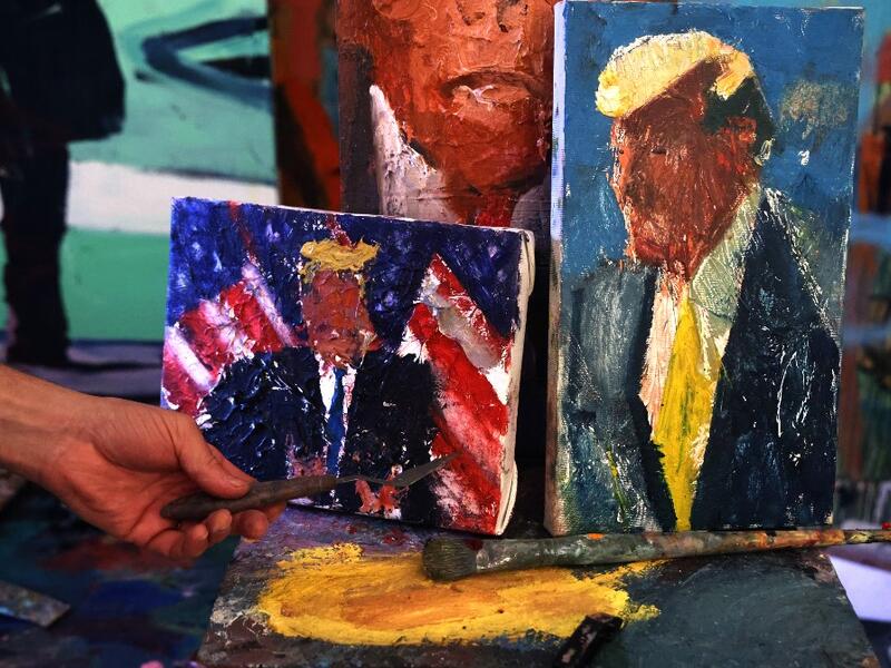Israeli painter Iddo Markus displays some of his paintings of former US president Donald Trump, at his studio in the northern port city of Haifa, on January 22, 2021. Markus became fascinated by the "tragic figure" of Donald Trump, and the walls and floor of his studio are packed with some 120 portraits of the former US presidents. Emmanuel DUNAND / AFP