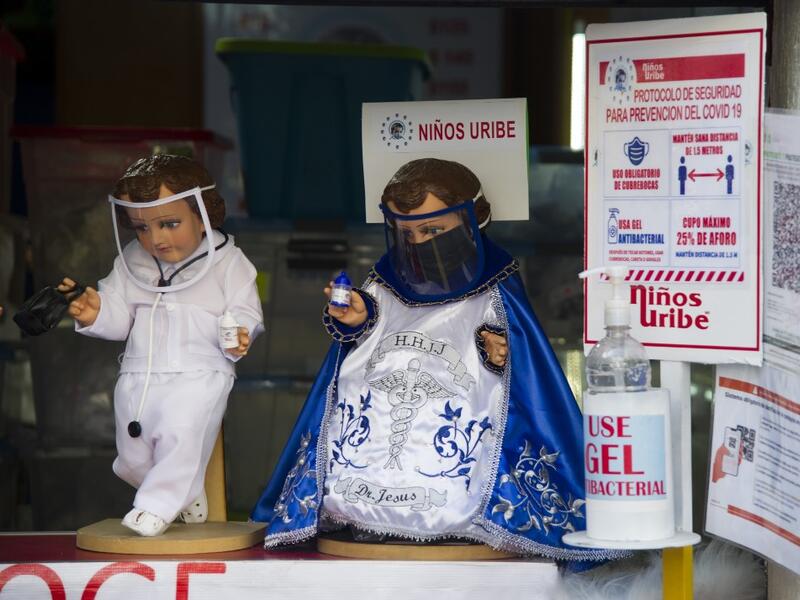 View of dolls displayed for sale at the ¨Nino Uribe¨ traditional Mexican store in Mexico City on January 27, 2021. ¨Nino Uribe¨ sells representations of the Baby Jesus called Baby COVID to raise awareness on the preventive measures to take amid the COVID-19 coronavirus pandemic. CLAUDIO CRUZ / AFP