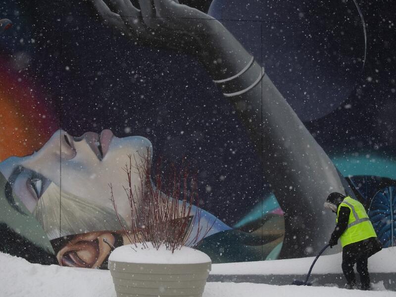A worker cleans the stairs outside The Vessel in Hudson Yards during a winter storm on February 1, 2021 in New York City. A powerful winter storm is set to dump feet of snow along a stretch of the US east coast including New York City on February 1, 2021, after blanketing the nation's capital. The National Weather Service issued storm warnings from Virginia to Maine -- a swathe home to tens of millions of people -- and forecast snowfall of 18 to 24 inches (45-60 centimeters) in southern New York, northeaste