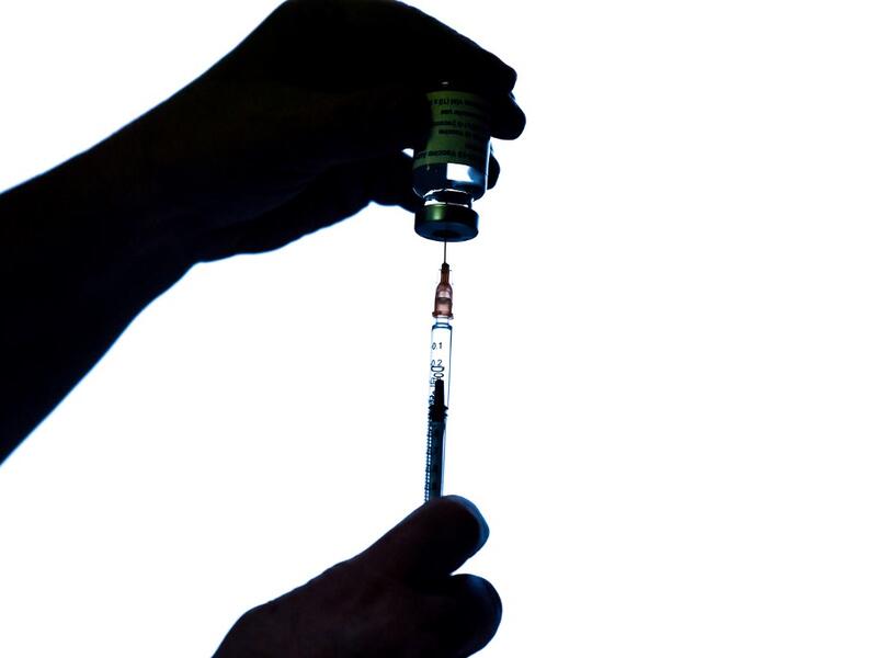 A health worker prepares an injection of the AstraZeneca/Oxford Covid-19 vaccine on February 7, 2021 at the Mignot Hospital in Le Chesnay near Paris. The top French medical authority Haute autorité de Santé has approved the vaccine for use in France, but only for people under 65, echoing decisions made in Sweden, Germany, Belgium and Switzerland over concerns about a lack of data on the effectiveness of the vaccine for over 65s.  ALAIN JOCARD / AFP