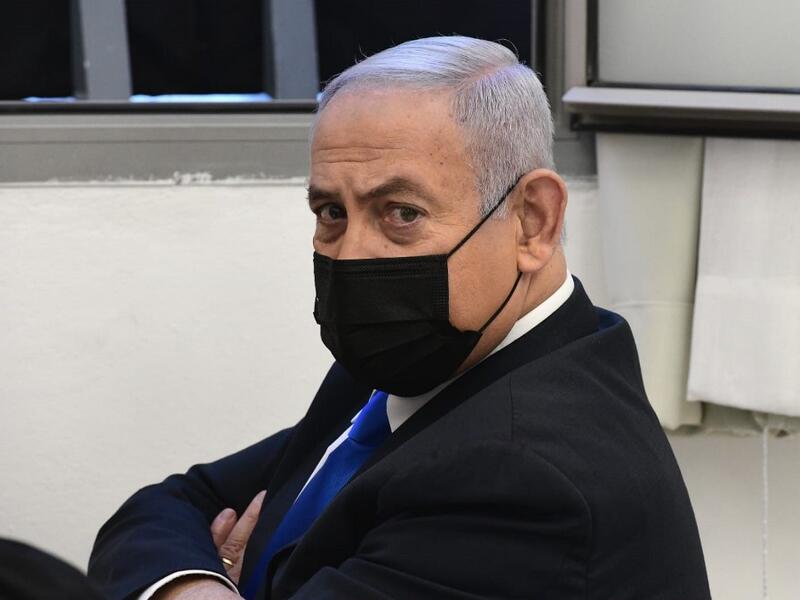 Israeli Prime Minister Benjamin Netanyahu looks on ahead of a hearing in his corruption trial at the Jerusalem district court, on February 8, 2021. Israel's Prime Minister Benjamin Netanyahu returns to court to formally respond to the corruption charges against him, as his trial enters an intensified phase six weeks before he faces re-election. POOL / AFP