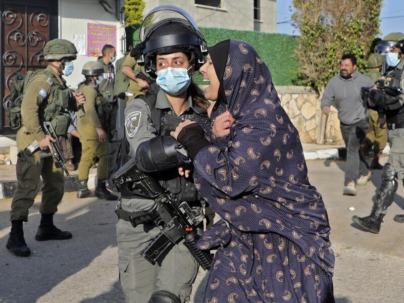 A woman reacts as Israeli security forces demolish the house of Palestinian Mohammed Cabha who has confessed to the murder of French-Israeli settler Esther Horgen, in the West Bank village of Tura al-Gharbiya near Jenin, on February 10, 2021. JAAFAR ASHTIYEH / AFP