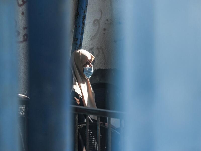 An elderly refugee awaits for UNRWA aid  