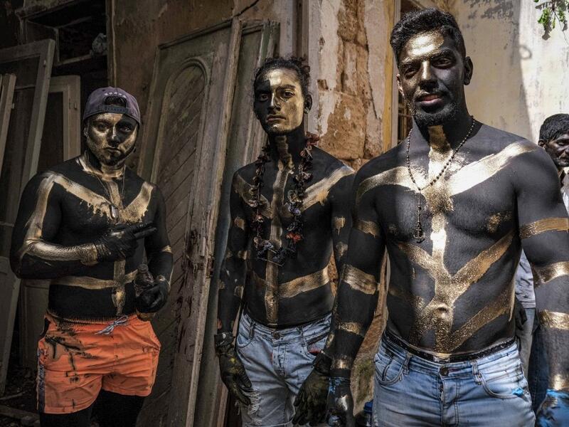 Carnival participants dressed in costume and wearing body paint 