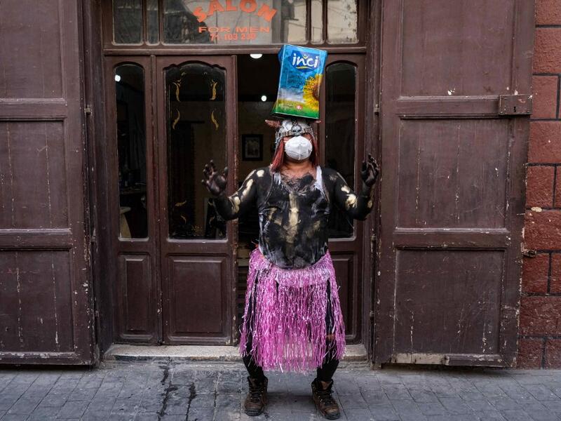A carnival participant dressed in costume and wearing body paint 