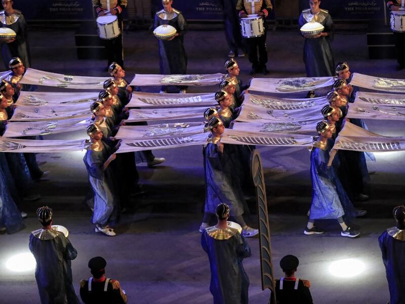 Performers dressed in ancient Egyptian costume march at the start of the parade of 22 ancient Egyptian royal mummies departing from the Egyptian Museum in Cairo's Tahrir Square 