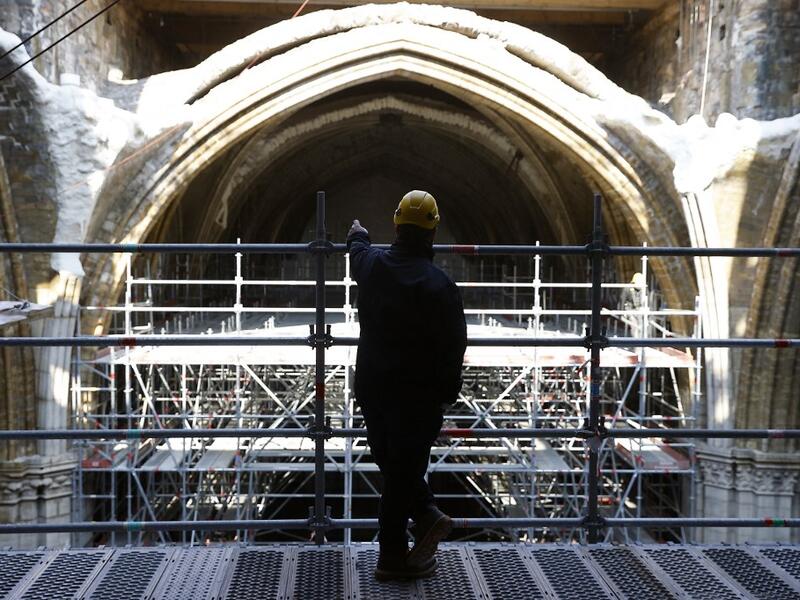 A workers looks at the vaults of the Notre-Dame de Paris Cathedral 