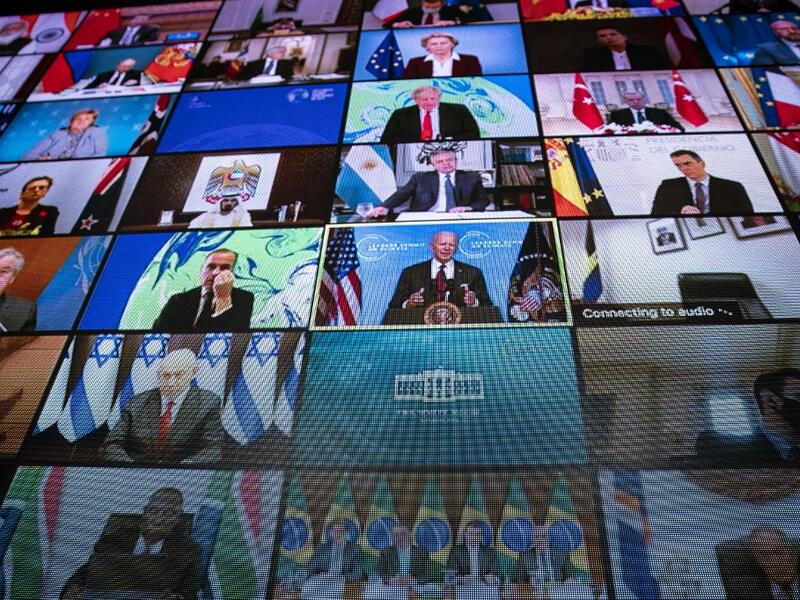 World leaders are seen remotely on a screen as U.S. President Joe Biden delivers remarks during a virtual Leaders Summit on Climate with 40 world leaders in the East Room of the White House 