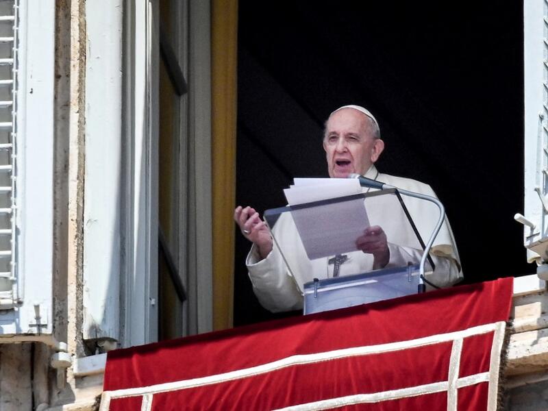 Pope Francis speaks from a window of the apostolic palace overlooking St. Peter's Square in the Vatican during the weekly Angelus prayer followed by the recitation of the Regina Coeli 