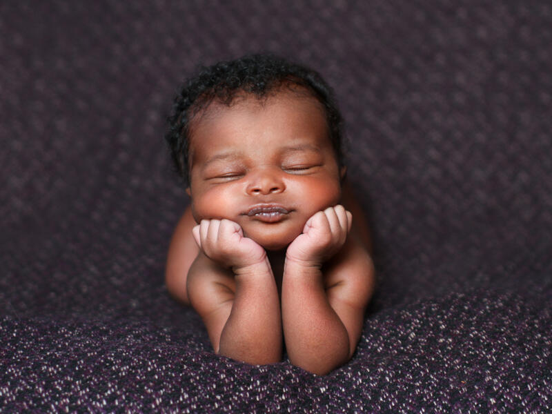 baby resting on her elbows and hands