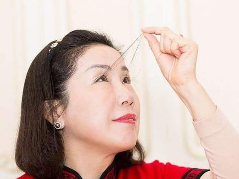 A woman in China with the world's longest eyelashes has broken her own record with an astonishing eight inch eyelash which she says was gifted by Buddha