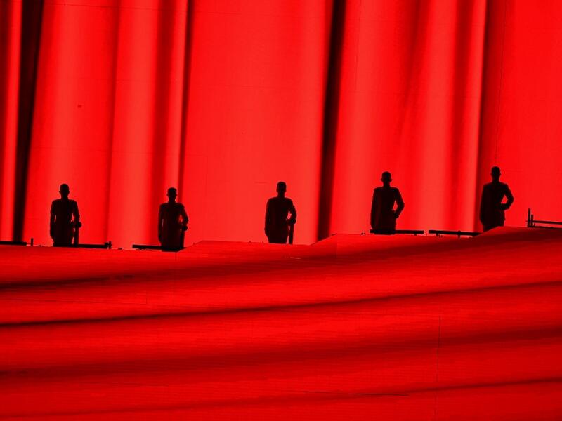 Performers are silhouetted as they take part in a Cultural Performance as part of the celebration of the 100th Anniversary of the Founding of the Communist Party of China, at the Bird's nest national stadium in Beijing 