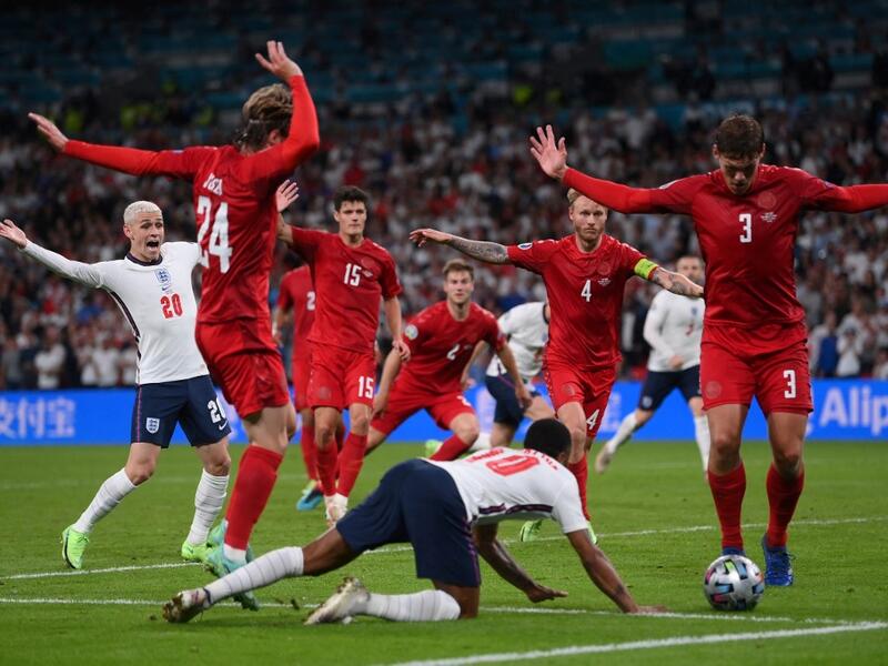 England's forward Raheem Sterling (C) falls on the ground which led to the awarding of a penalty during the UEFA EURO 2020 semi-final football match between England and Denmark at Wembley Stadium in London on July 7, 2021. (Photo: AFP)