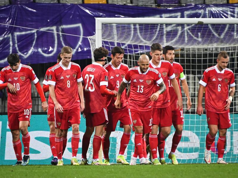 Russia’s players celebrate after scoring a goal during the FIFA World Cup Qatar 2022 qualification Group H football match between Slovenia and Russia at the Ljudski vrt Stadium in Maribor on October 11, 2021. (Photo by Jure Makovec / AFP)
