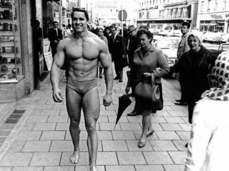 Arnold Schwarzenegger promoting his own gym in Munich wearing nothing but swim trunks November, 1967.