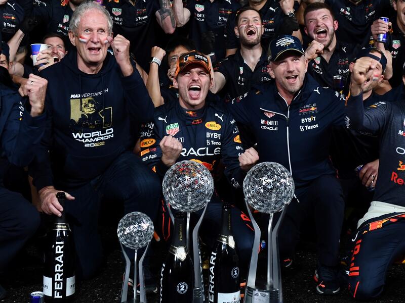 Red Bull Racing's Dutch driver Max Verstappen (front C) celebrates winning the season's world championship with his team after his victory at the Formula One Japanese Grand Prix at Suzuka, Mie prefecture on October 9, 2022. (Photo by Toshifumi KITAMURA / AFP)