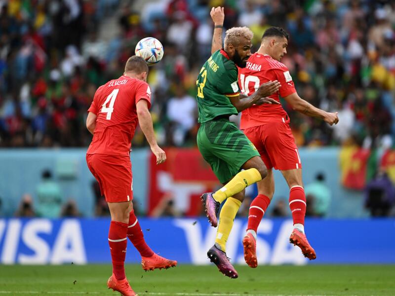 Cameroon's forward #13 Eric Maxim Choupo-Moting (C) fights for the ball with Switzerland's defender #04 Nico Elvedi (L) and Switzerland's midfielder #10 Granit Xhaka during the Qatar 2022 World Cup Group G football match between Switzerland and Cameroon at the Al-Janoub Stadium in Al-Wakrah, south of Doha on November 24, 2022. (Photo by Fabrice COFFRINI / AFP)