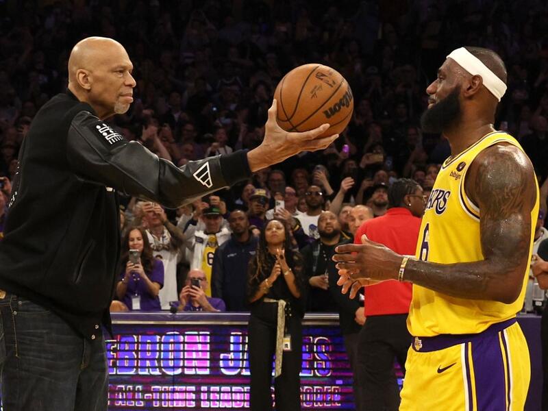 NBA Commissioner Adam Silver looks on as Kareem Abdul-Jabbar ceremoniously hands LeBron James #6 of the Los Angeles Lakers the ball after James passed Abdul-Jabbar to become the NBA's all-time leading scorer, surpassing Abdul-Jabbar's career total of 38,387 points against the Oklahoma City Thunder at Crypto.com Arena on February 07, 2023 in Los Angeles, California. (Photo by Harry How / GETTY IMAGES NORTH AMERICA / Getty Images via AFP)