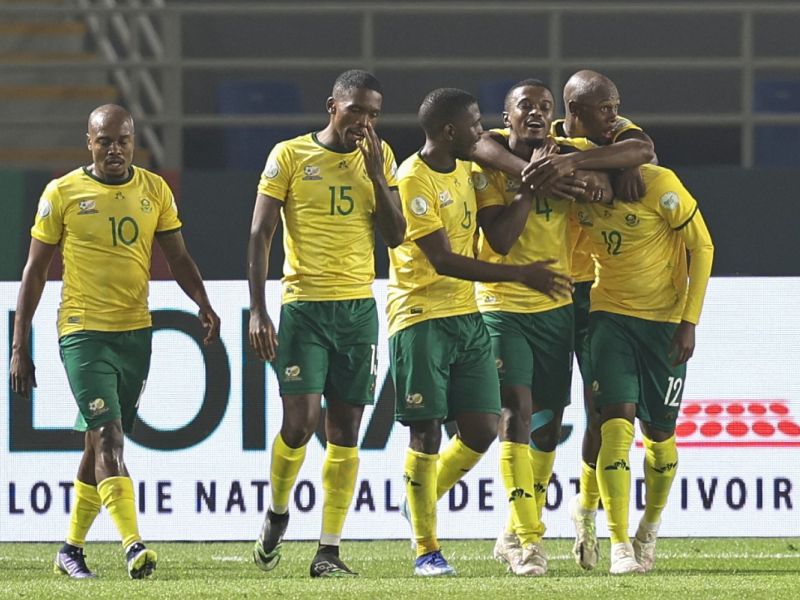South Africa's defender #12 Thapelo Maseko celebrates with teammates after scoring his team's fourth goal during the Africa Cup of Nations (CAN) 2024 group E football match between South Africa and Namibia at Amadou Gon Coulibaly Stadium in Korhogo on January 21, 2024. (Photo by Fadel Senna / AFP)
