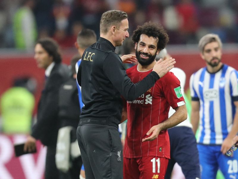 Liverpool's Dutch assistant manager Pepijn Lijnders (L) speaks with Liverpool's Egyptian midfielder Mohamed Salah following the 2019 FIFA Club World Cup semi-final football match between Mexico's Monterrey and England's Liverpool at the Khalifa International Stadium in the Qatari capital Doha on December 18, 2019. Liverpool will face Flamengo in the Final of the FIFA Club World Cup on December 21. / AFP / KARIM JAAFAR
