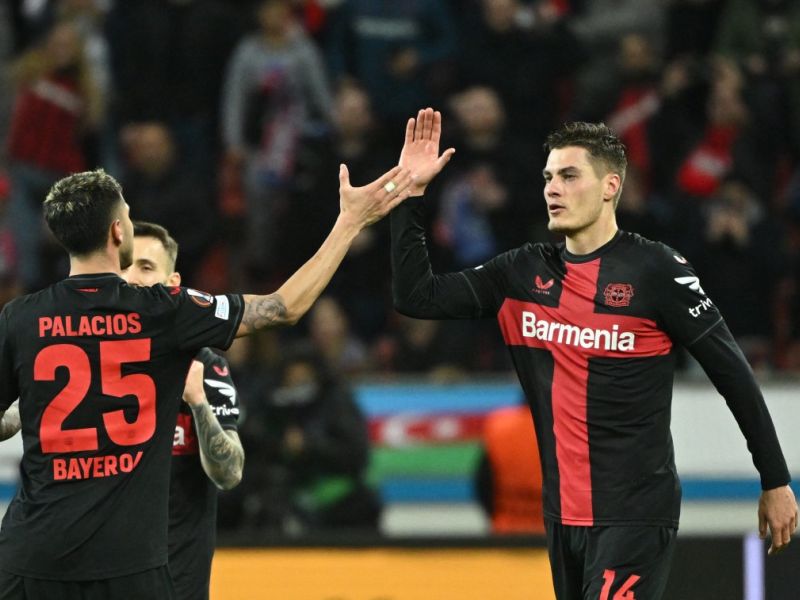 Bayer Leverkusen's Czech forward #14 Patrik Schick (C) celebrates scoring the 3-2 goal with team mate Bayer Leverkusen's Argentine midfielder #25 Exequiel Palacios during the UEFA Europa League Group round of 16, second-leg football match between Bayer 04 Leverkusen and Garabagh in Leverkusen, western Germany on March 14, 2024. (Photo by INA FASSBENDER / AFP)