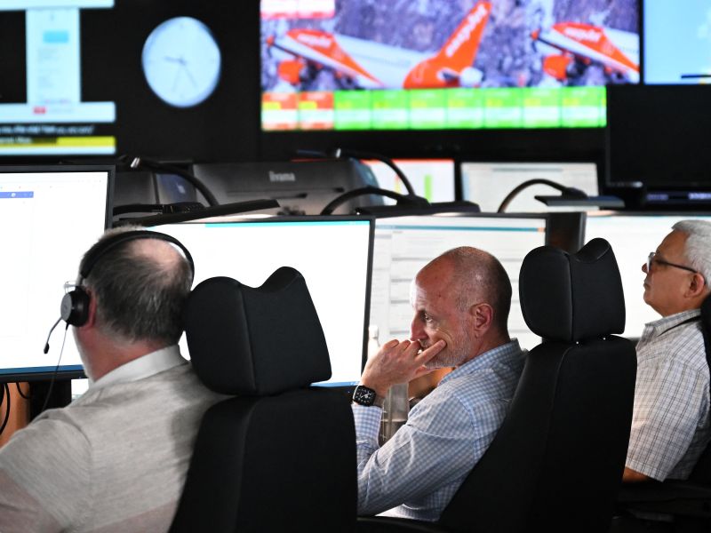 Members of staff work on computers in the Network Control Room inside Easyjet's new operations Integrated Control Centre (ICC) in Luton, north of London on May 22, 2024. A cutting-edge facility featuring artificial intelligence (AI) -- Easyjet's new control centre is tasked with handling about 2,000 mostly-European flights per day as the British airline eyes record summer demand. (Photo by Justin TALLIS / AFP)
