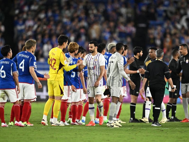 Yokohama (L) shake hands with Al Ain (R) at the end of the AFC Champions League final first leg football match between UAE's Al Ain and Japan's Yokohama F. Marinos at Nissan Stadium in Yokohama, Kanagawa prefecture, south of Tokyo, on May 11, 2024. (Photo by Philip FONG / AFP)