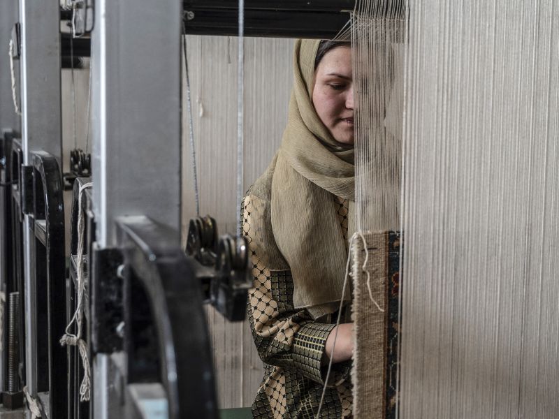 Afghan women weave carpets at a factory on the outskirts of Kabul. Many women have launched small businesses in the past three years to meet their own needs and support other Afghan women (Photo by AFP)