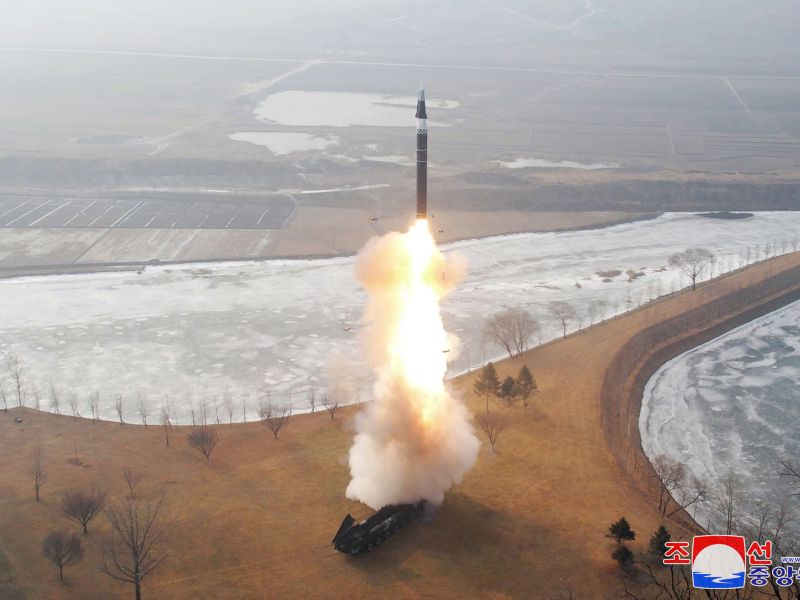 Missile accelerates in sky with bright flame from rocket engine nozzle