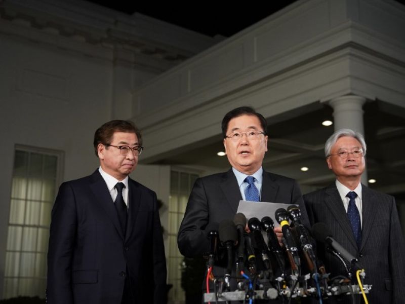 South Korean National Security Advisor Chung Eui-yong (C), flanked by South Korea National Intelligence Service chief Suh Hoon (L) and South Korea's ambassador to the United States Cho Yoon-je (R), briefs reporters outside the West Wing of the White House on Mar. 8, 2018 in Washington, DC, announcing North Korean leader Kim Jong Un has offered to meet U.S. President Donald Trump. 
(MANDEL NGAN / AFP)