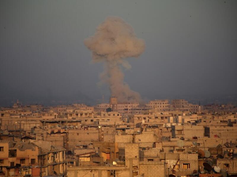 Smoke billows in Zamalka, in the Syrian rebel enclave of Eastern Ghouta on the outskirts of Damascus, during reported shelling by Syrian government forces on Mar. 12, 2018. (Ammar SULEIMAN / AFP)