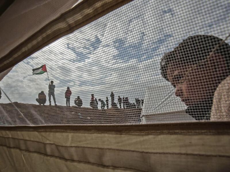 A Palestinian child stands outside a tent during a a tent city protest near Khan Yunis in the southern Gaza Strip on Mar. 30, 2018. Land Day marks the killing of six Arab Israelis during 1976 demonstrations against Israeli confiscations of Arab land.
(SAID KHATIB / AFP)