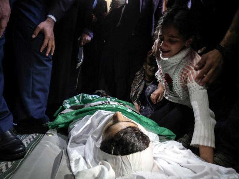 Relatives mourn over the body of Alaa al-Zamili, a teenager who died the day before from wounds sustained in clashes with Israeli forces on the border with Israel, during his funeral on Apr. 7, 2018, in the southern Gaza Strip town of Rafah. 
(SAID KHATIB / AFP)