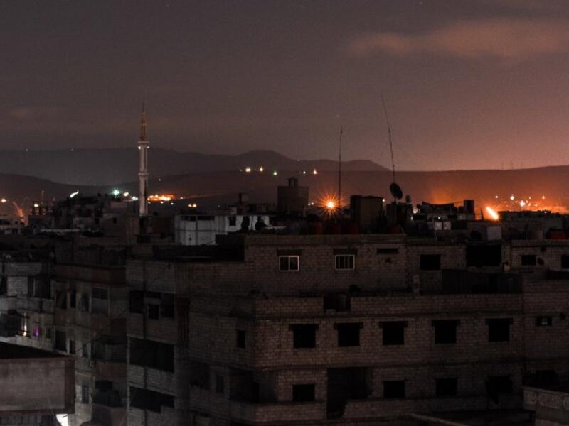 A picture taken early on Apr. 21, 2018 shows explosions appearing in the skyline of a southern district of the Syrian capital Damascus, during regime strikes targeting the Islamic State group in the Palestinian camp of Yarmouk, and neighbouring districts. 
(Rami al SAYED / AFP)