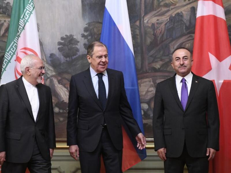 Russian Foreign Minister Sergei Lavrov (C), his Turkish counterpart Mevlut Cavusoglu (R) and Iran's Foreign Minister Mohammad Javad Zarif pose for pictures prior to their meeting in Moscow on April 28, 2018. Alexander NEMENOV / AFP