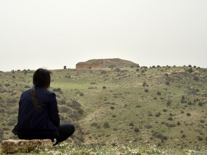 A woman observes one of the Jeddars pyramid tombs, near the city of Tiaret, some 250 kilometres (155 miles) southwest of the Algerian capital, on April 23, 2018.
RYAD KRAMDI / AFP