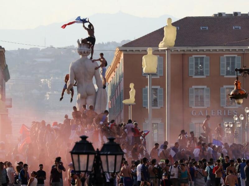 People wave a French flag and celebrate after France won the Russia 2018 World Cup final football match against Croatia, on July 15, 2018 in Nice, on the French Riviera. 
Valery HACHE / AFP