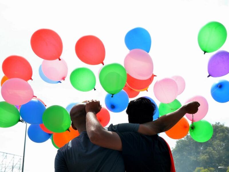 Indian members and supporters of the lesbian, gay, bisexual, transgender (LGBT) community celebrate the Supreme Court decision to strike down a colonial-era ban on gay sex, in Bangalore on September 6, 2018. 
MANJUNATH KIRAN / AFP
