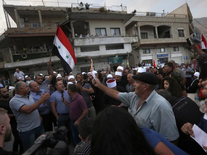 Druze residents of Majdal Shams in the Israeli-annexed Golan Heights set ablaze makeshift ballot papers during a protest. (JALAA MAREY / AFP)