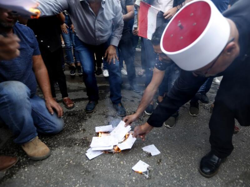 Druze residents of Majdal Shams in the Israeli-annexed Golan Heights set ablaze makeshift ballot papers during a protest on October 19, 2018. (JALAA MAREY / AFP)