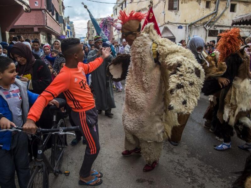 Young Moroccans take part in the Boujloud festival, a popular celebration also known as the 'Moroccan Halloween' in the Sidi Moussa district of Sale near Rabat, on October 27, 2018. 
FADEL SENNA / AFP